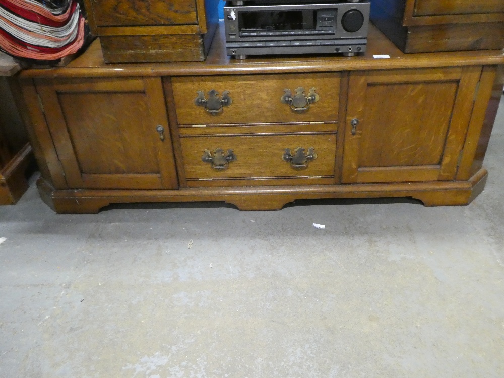 Low wooden cabinet with two central drop flap drawers flanked by cups