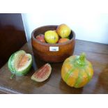 An old turned wood bowl with various painted wooden fruits