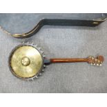 An old four string Banjo by Zimmermann having cymbal back.