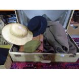Vintage suitcase containing old hats, rucksack and gents coat