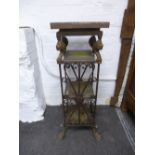 A metal four tier stand decorated lion's heads on paw feet, height 91 cms