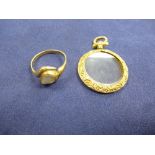 Victorian 9ct yellow gold and glass double sided locket with embossed decoration, together with a