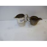 Two Victorian silver cream jugs, one with half gadroon decorated body, together with a smaller