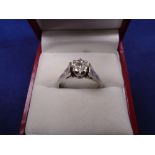 18ct white gold ring with illusion set diamond and bright cut shoulders, stamped 750, size Q/R,