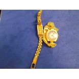 An 18ct yellow gold lady's wristwatch with silvered dial/chapter ring, on an 18ct mesh style