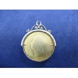 Rare 1825 George IV milled silver gilt shilling, well worn, in a white coloured metal mount, gross