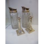 Pair of moulded clear glass jugs with silver plated mounts, 29cm high, together with a pair of