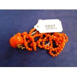 Old red coral bead necklace with tassel style pendant with yellow coloured metal mounts, approx 37cm