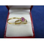 9ct yellow gold ring set with a pink coloured stone flanked by 2 small diamonds shank stamped 375,