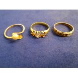 Yellow coloured metal ring set with a diamond, 2 diamonds either side messing, unmarked shank,