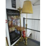 An old brass extending standard lamp table having marble top with ornate base and an brass arts &