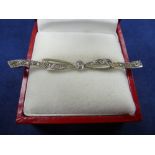 Edwardian white coloured metal ribbon tie bar brooch set with diamonds, larg 0.10ct,. gross item