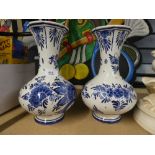 A pair of hand painted blue and white Dutch vases