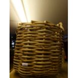 A large wicker log basket with handles