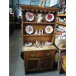 Waxed pine cottage dresser with open rack above drawer and cupboard