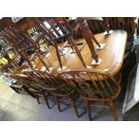 Large mahogany extending dining table on bulbous supports and set of 8 wheelback dining chair of