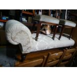 Victorian mahogany framed chaise longue in cream damask fabric, on castors