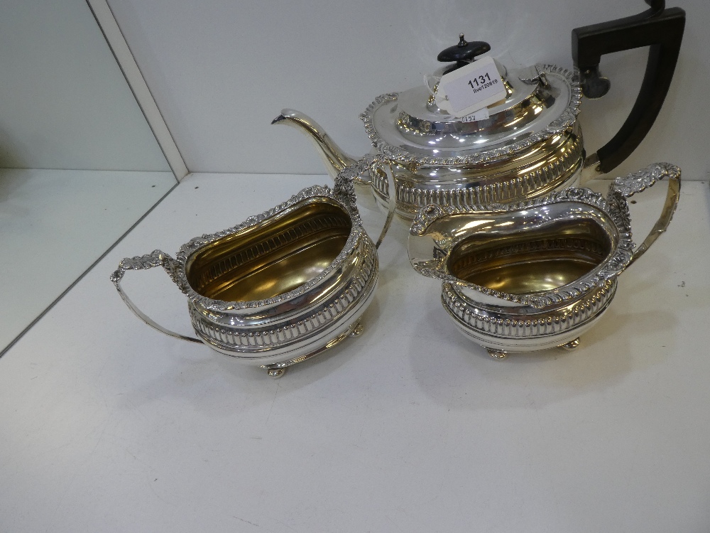 Early 20th century silver three piece set comprising tea pot with reeded decoration, gadroon & shell