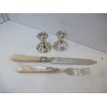 A pair of low candle sticks silver Birmingham 1930 and a silver decorative knife with a pearl handle
