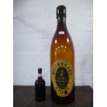 An Eldridge Pope sealed bottle of Ale, 1926 and a Whitbread oversized advertising bottle