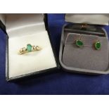 9ct yellow gold ring set with a green coloured stone flanked to either side with a diamond,