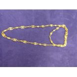 Middle Eastern yellow coloured metal necklace, oval pierced design, unmarked 29cm long. 12.2g.