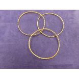 Three middle eastern yellow coloured metal childrens bangles, unmarked 22.3g