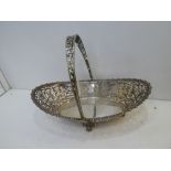 Edwardian silver boat shaped basket with pierced decoration, gadroon edge, swing handle on 4 lion