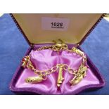 9ct yellow gold charm bracelet hung with 8 charms including cat, ship etc. stamped 375, 22.2g