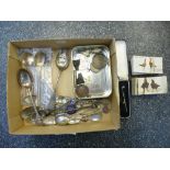Box of collectibles including old animal charms, silver souvenir and other spoons, etc.