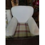 Cream upholstered armchair with tartan covered seat