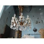 Brass 8 branch electrolier hung with glass pendants