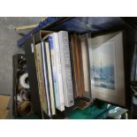 A box of ship memorabilia to include Queen Mary 2 book, Queen Victoria Book, framed pictures and