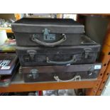 Three small vintage suitcases