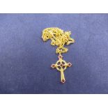 9ct yellow gold cross style pendant set with rubies and diamond clips on a 9ct yellow gold neckchain