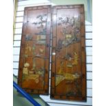 A pair of Oriental wooden panels having raised decoration and one other Oriental picture.