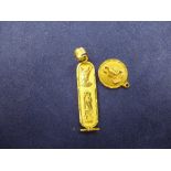 Yellow coloured metal pendant with Egyptian hieroglyphs, unmarked, together with a 9ct yellow gold