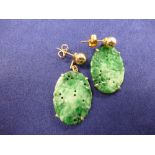 Pair of Oriental yellow coloured metal & carved oval jade earrings, approx. 3.5cm long X 2cm wide,