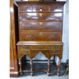 An 18th century walnut chest on stand having eleven drawers with feather banded decoration 103cms.