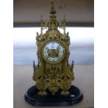 A Victorian gilt metal mantle clock having ornate pierced decoration of ecclesiastical design 49cms.