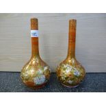 Pair of Japanese Kutani vases, spherical form, tapered necks, decorated with exotic birds &