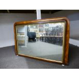 A Victorian walnut over mantle mirror with ebony and inlaid decoration, 103cms