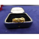 22ct yellow gold buckle style ring set with a small diamond chip stamped 22, size R together with