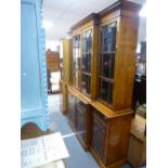 A reproduction Yew breakfront bookcase, 183 cms
