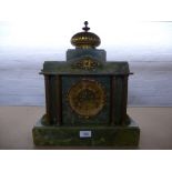 An Ansonia onyx mantle clock having gilt columns, 36cms.