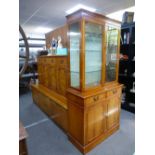 A reproduction Yew sideboard, a similar glazed bookcase and a Meredew teak sideboard