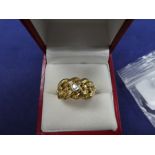 18ct yellow gold knot style ring set with a diamond approx 0.20cts, stamped 18 makers mark W.M, size