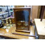 An old oak smokers cabinet having three drawers and a single glazed door.