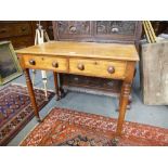 A Victorian mahogany two drawer side table on turned legs