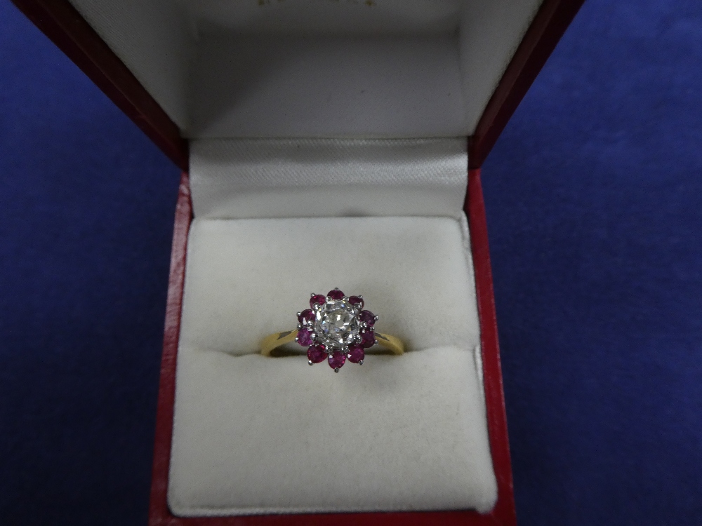 Diamond & ruby cluster ring, central diamond surrounded by 10 rubies on an 18ct yellow gold shank